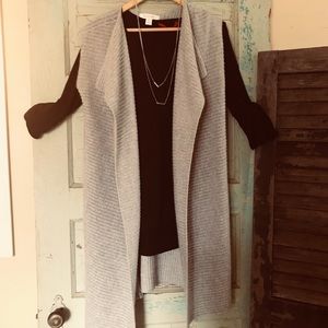 Long sleeveless sweater vest.
